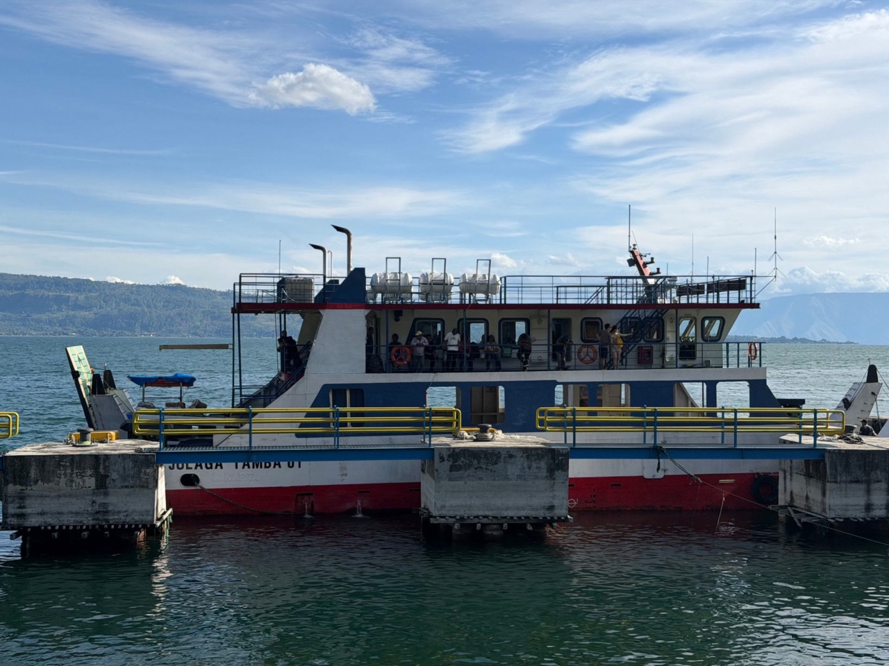 A passenger ferry at a pier on Lake Toba