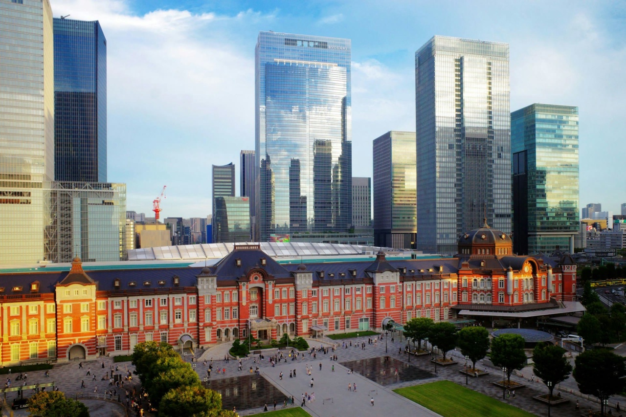 Tokyo Station with skyscrapers behind the historic station building