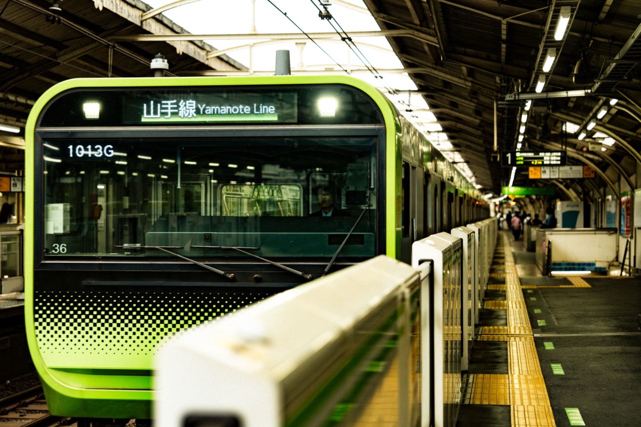 A green Yamanote Line train at the platform