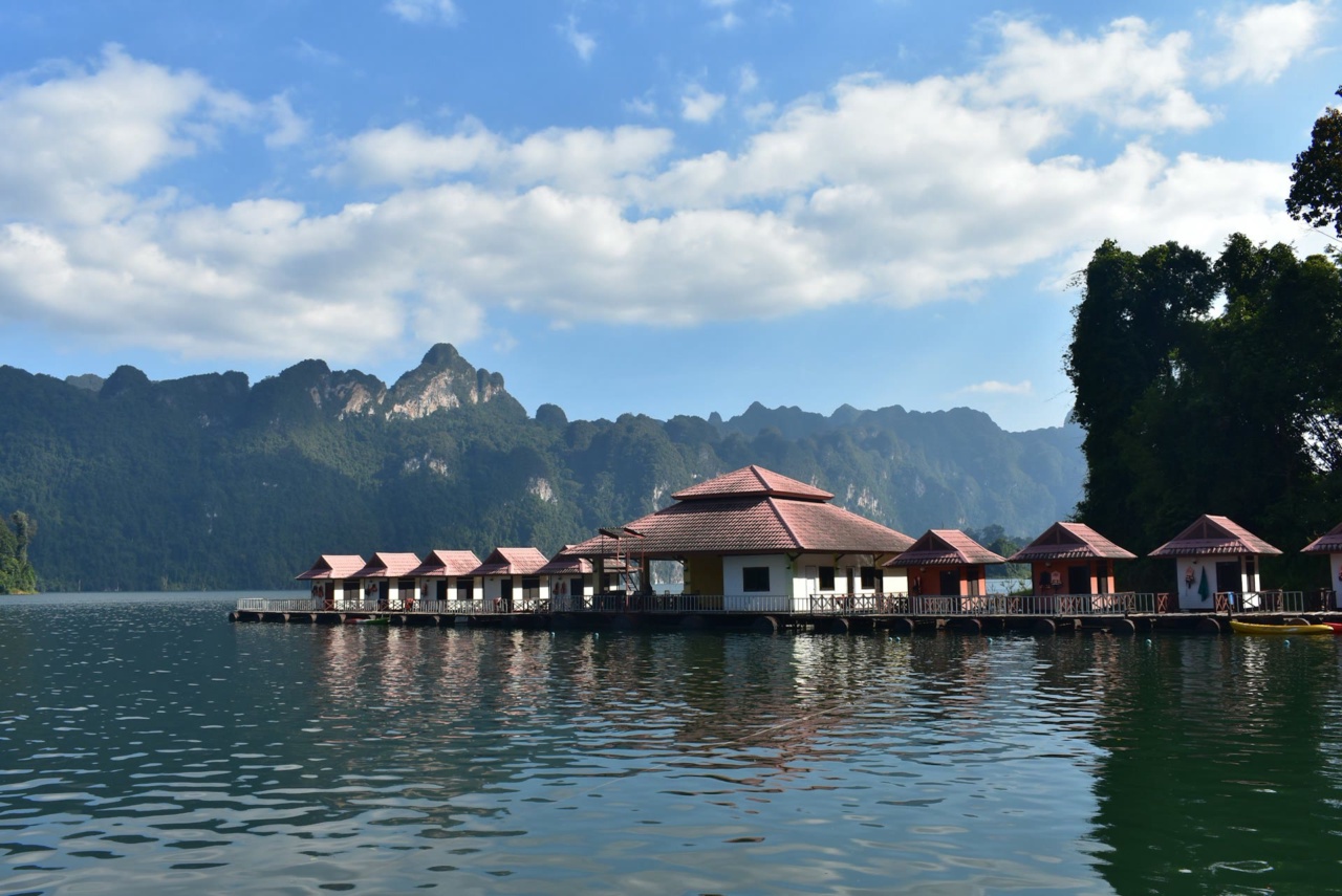 Huts on the water at Cheow Lan Lake, with forested mountains behind
