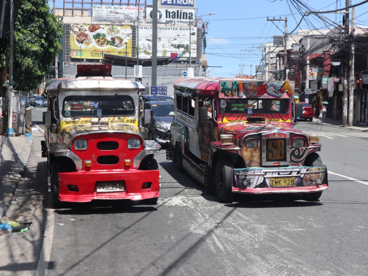 Two colorful jeepneys on a street in Manila