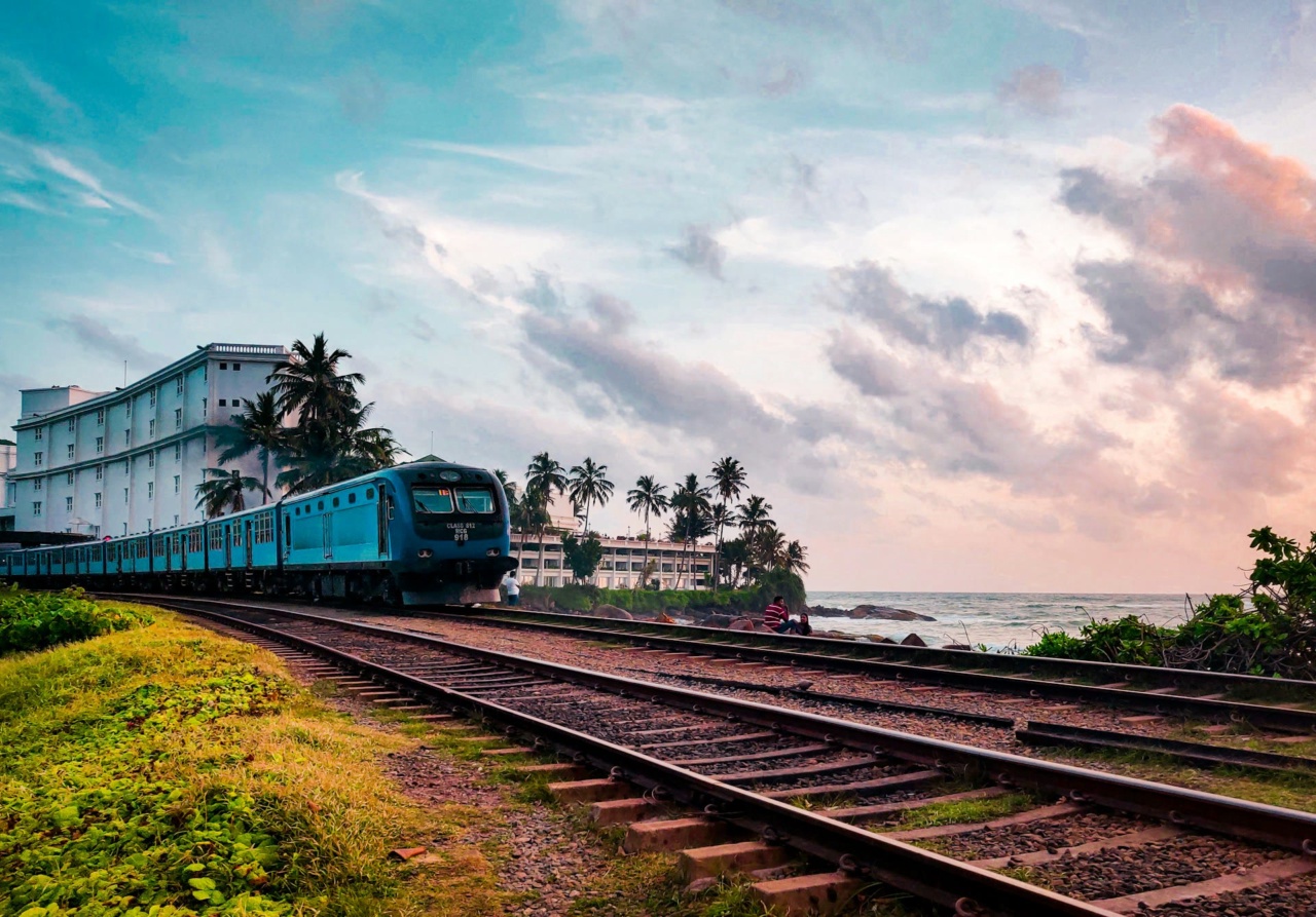 A passenger train on the coastal railway line right beside the sea