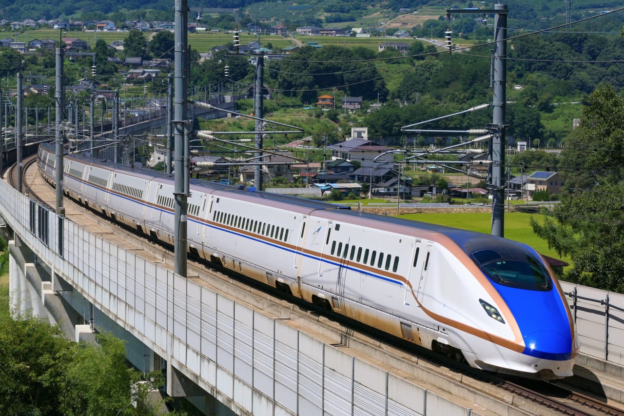 A Hokuriku Shinkansen train on an elevated line