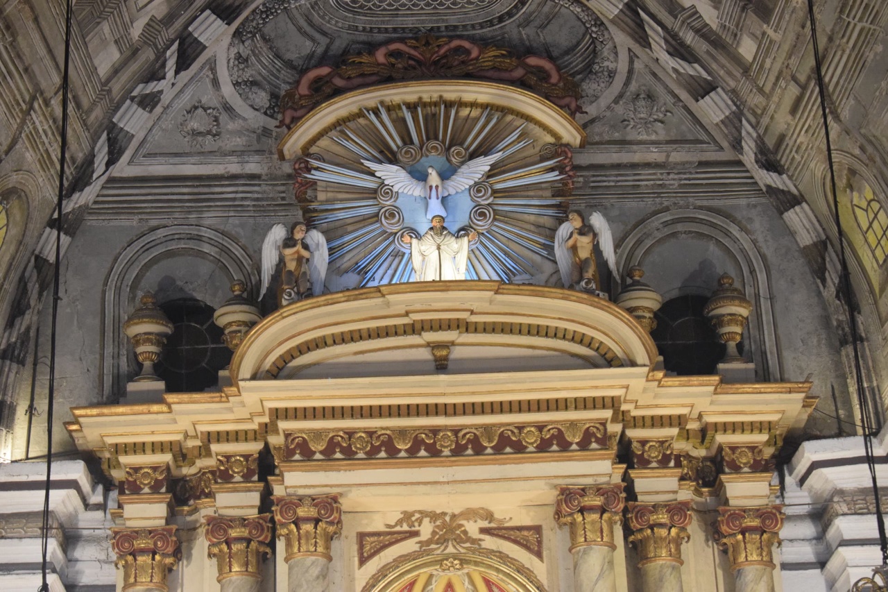 The altar and painted ceiling inside San Agustin Church in Intramuros