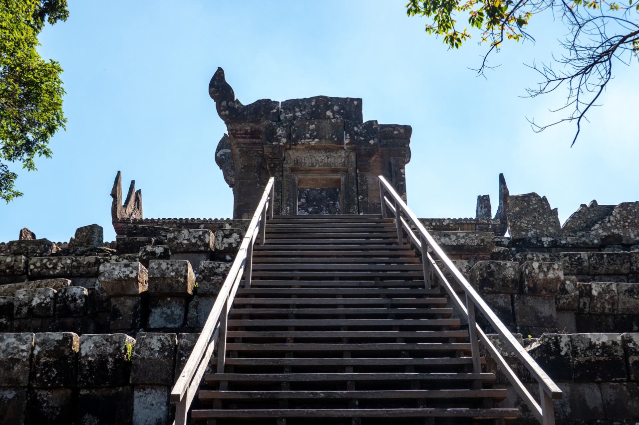 A stone staircase with handrails leading up to a structure at Preah Vihear