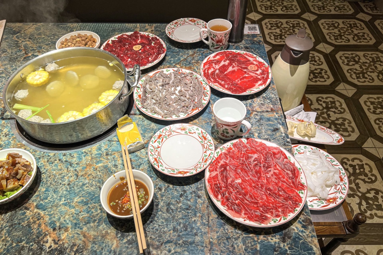 Chaoshan-style beef hot pot with plates of sliced raw beef